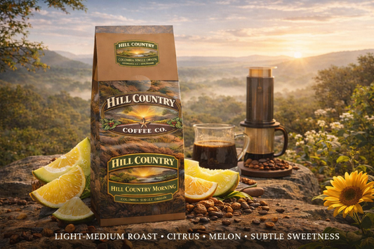 Hill Country Coffee Co. package with coffee and lemon slices on a scenic background